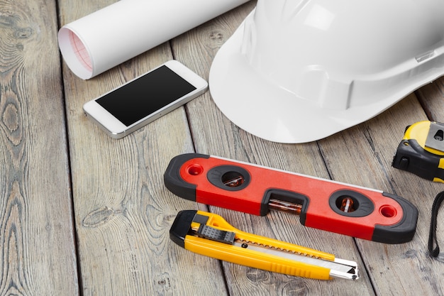 Construction  worker supplies and instruments on wooden table