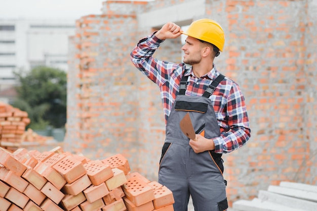 Construction worker in uniform and safety equipment have job on building Industrial theme