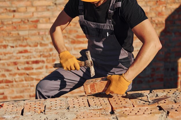 Construction worker in uniform and safety equipment have job on building