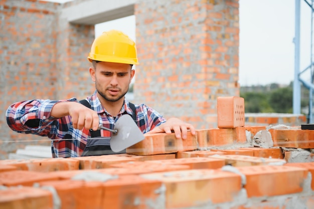 Construction worker in uniform and safety equipment have job on building