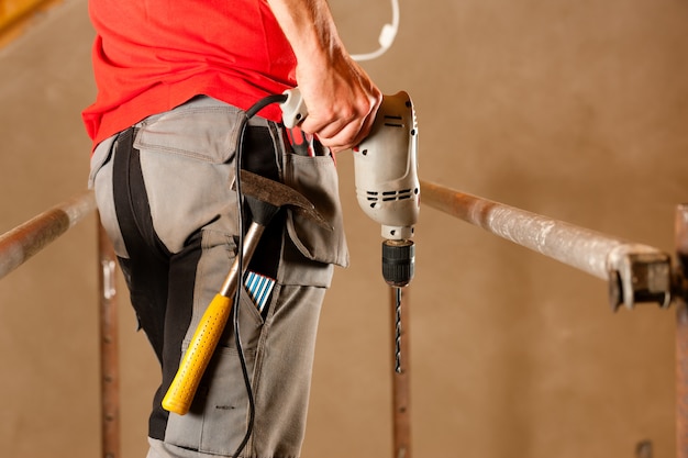 Photo construction worker with hand drill