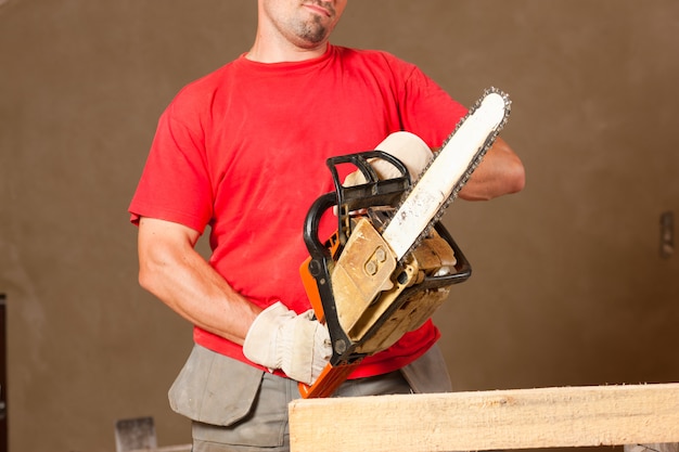 Construction worker with motor saw