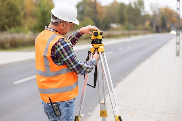 Construction workers setting equipment in the middle of the road structure