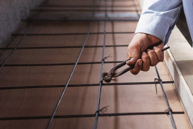 Construction workers tying the steel reinforced concrete.