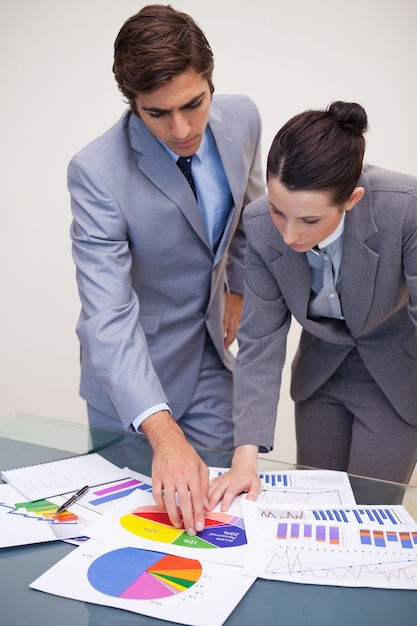 Consultant and customer looking at statistics