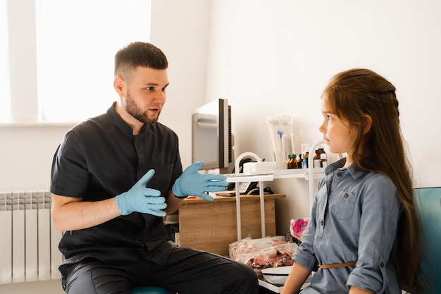 Consultation of kid with a pediatric otolaryngologist in a medical clinic Nose examination of the child