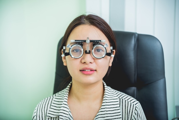 Consultation with an ophthalmologist. Young asian woman in clinic office.