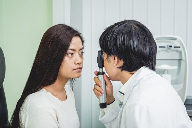 Consultation with an ophthalmologist. Young asian woman and doctor