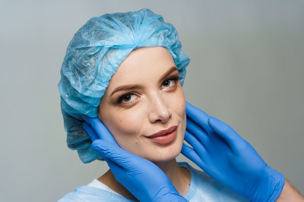 Consultation with plastic surgeon on white surface