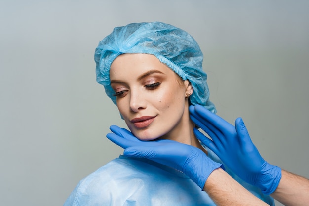 Consultation with plastic surgeon on white surface