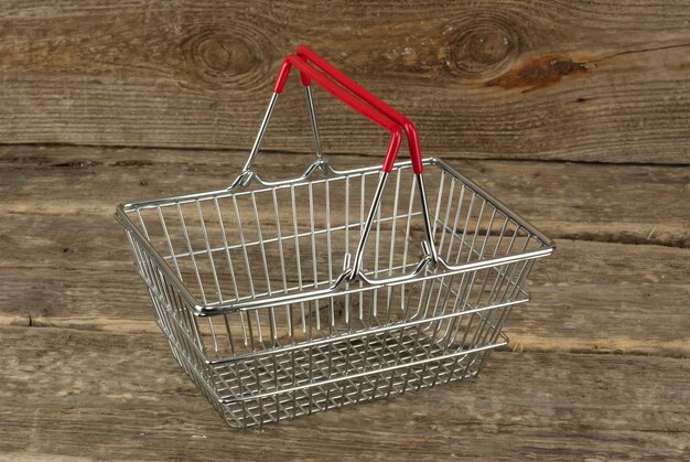 Consumer basket on the wooden background