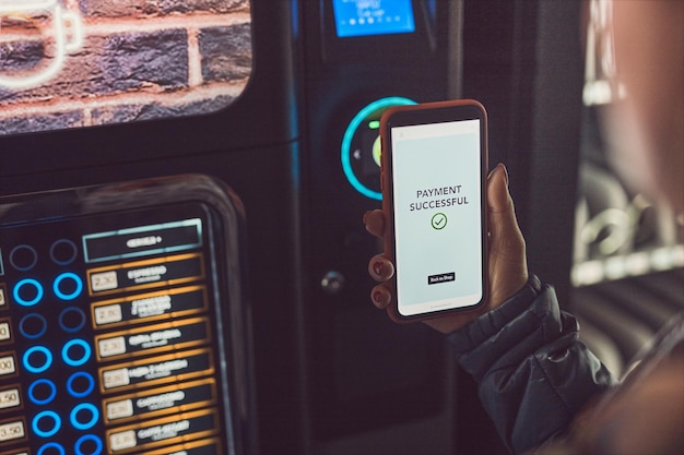 consumer paying for product at vending machine using contactless method of payment with mobile phone