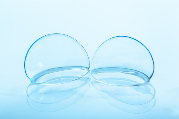 Contact lens on blue background