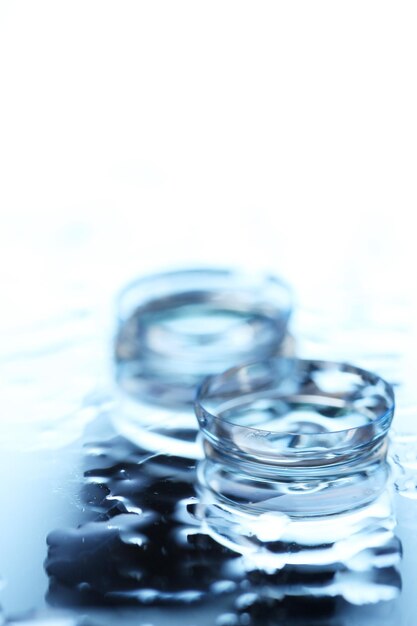 Contact lens with drops on blue background