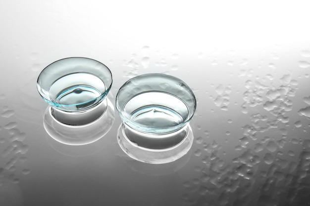 Contact lenses on wet glass background