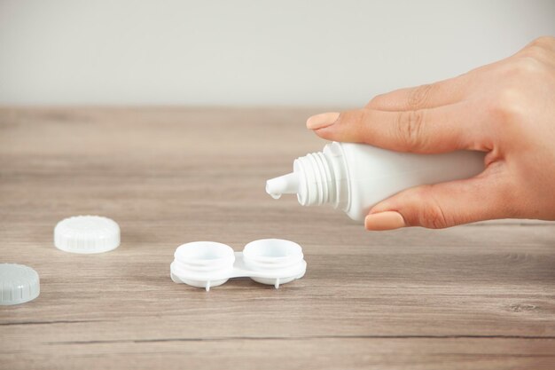 Contact lenses with solution in woman hands