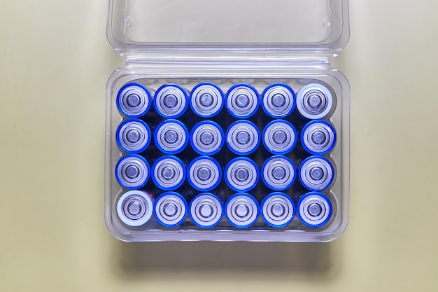 Photo a container of blue batteries with a white label in the middle.