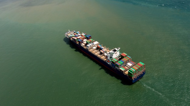 Container ship export and import business services and logistics. Shipping cargo to harbor  transport International. Aerial view