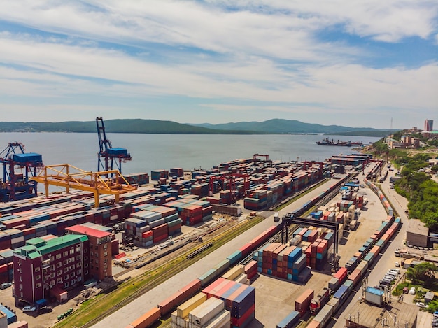 Container ship in import export and business logistic By crane Trade Port Shipping cargo to harbor Aerial view from drone International transportation Business logistics concept