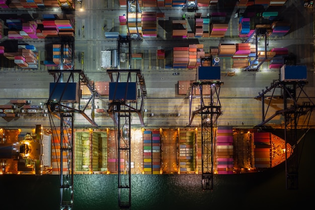 Container ship loading and u in deep sea port, Aerial view of business service and industry cargo logistic import and export freight transportation by container ship in open sea,