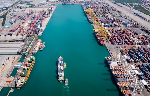 Container ship at sea port and working crane bridge loading un loading container for import export international by shipping transportation business and industry delivery service