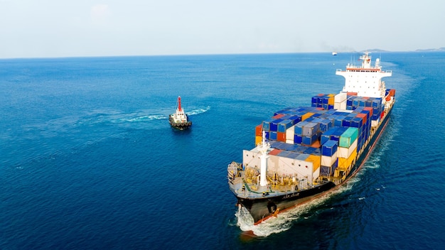 Container ship was dragged by tug boat to international cargo port for service transportation logistic service transportation and maintenance concept