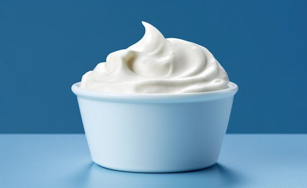 a container of whipped cream with a blue background.