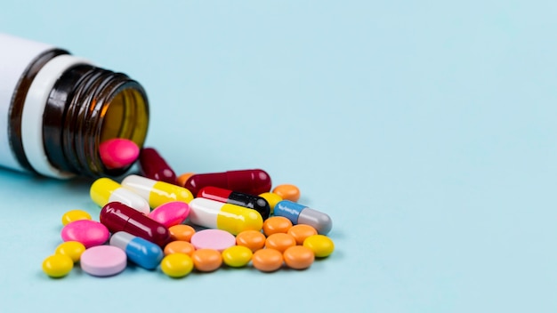 Container with pills on table