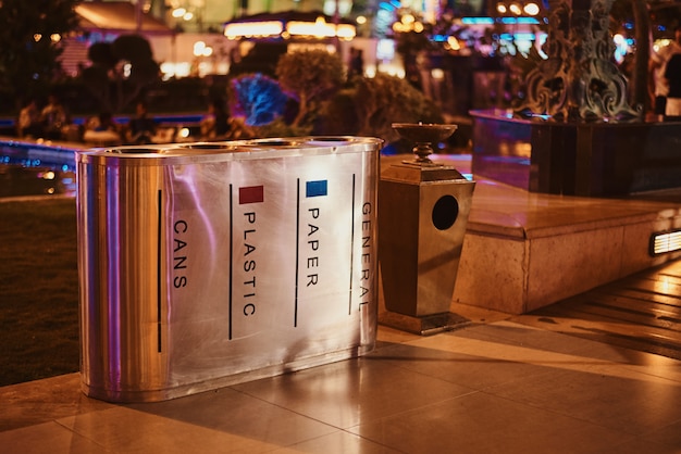 Photo containers for separate waste collection in the night city street