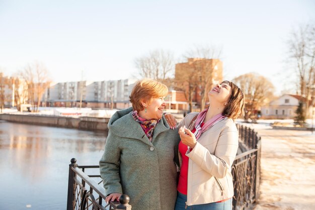 Contemplative casual senior women looking away at embankmentxAxA