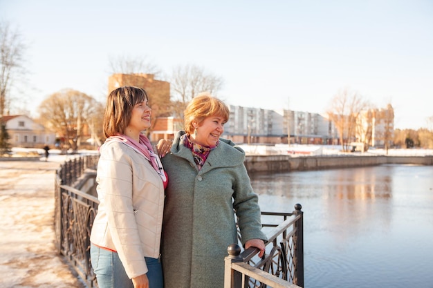 Contemplative casual senior women looking away at embankmentxAxA