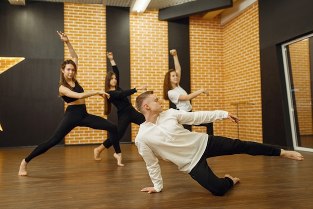 Contemporary dance performers posing in studio.