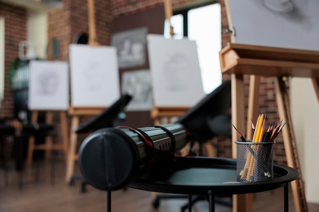 Contemporary educational empty studio with nobody in it ready for students to attend drawing class. School classroom equipped with painting canvas, drawing professional tools. Creative concept