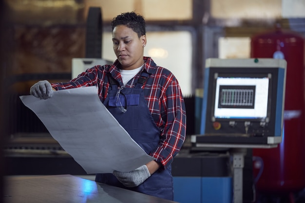 Contemporary Female Engineer Holding Plans