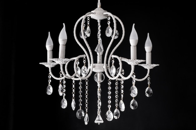 Contemporary glass white chandelier isolated over black background