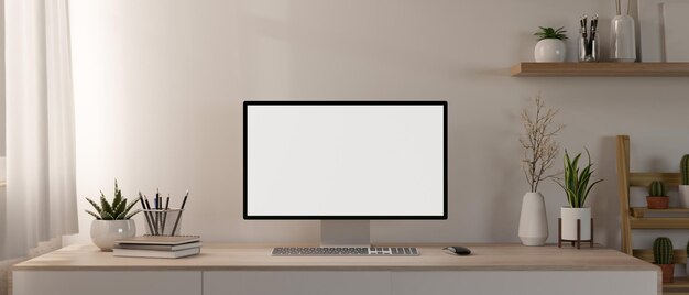 Foto un ufficio domestico minimalista contemporaneo presenta un modello di computer e un decoro su un tavolo di legno minimo