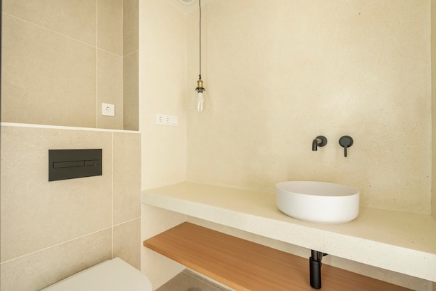 Contemporary minimalist washbasin with lamp and worktop