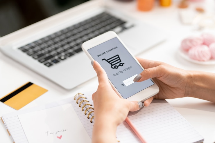 Photo contemporary young female customer with smartphone searching goods in online shop while going to make order