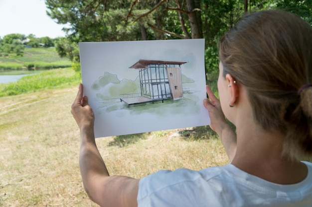 Photo contemporay house design hand drawn sketch in architecht's hands