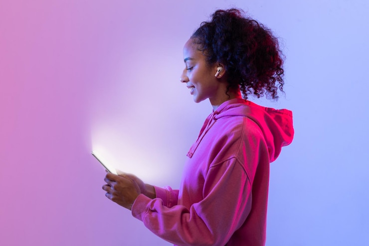 Photo content black lady in hoodie using phone neon light glow