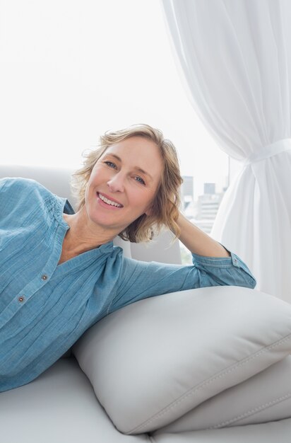 Content blonde woman relaxing on her couch