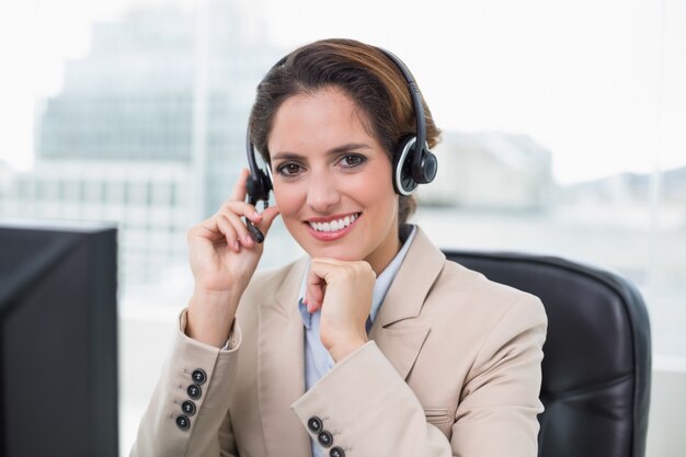 Content businesswoman touching headset