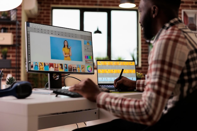 Content creator editing picture with retoucher software on computer, creating multimedia production image. Freelancer editor retouching photo with colorist interface app and creativity.