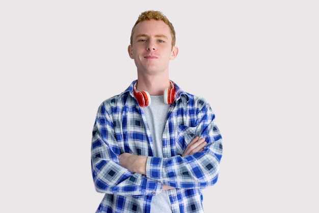 Content Red Haired Student with Headphones on Neck