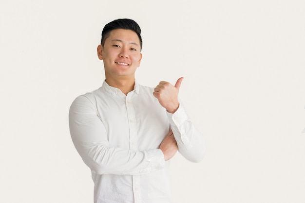 Content successful asian manager showing thumb-up