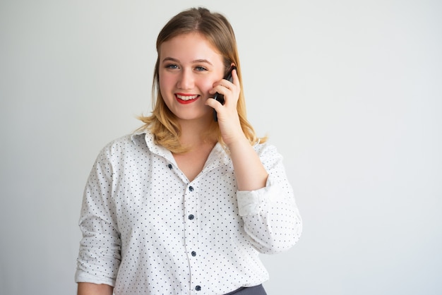 Content successful saleswoman talking on phone