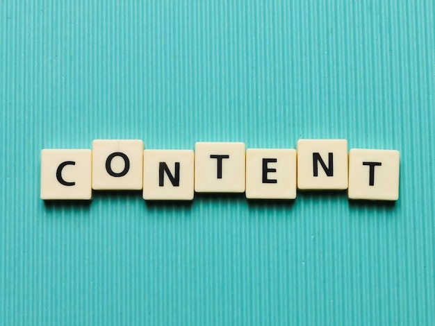 CONTENT word made from square letter tiles on turquoise background.