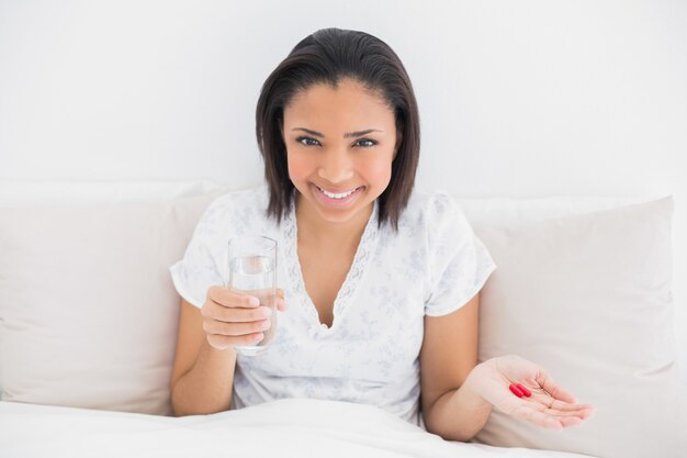 Content young dark haired model taking medication