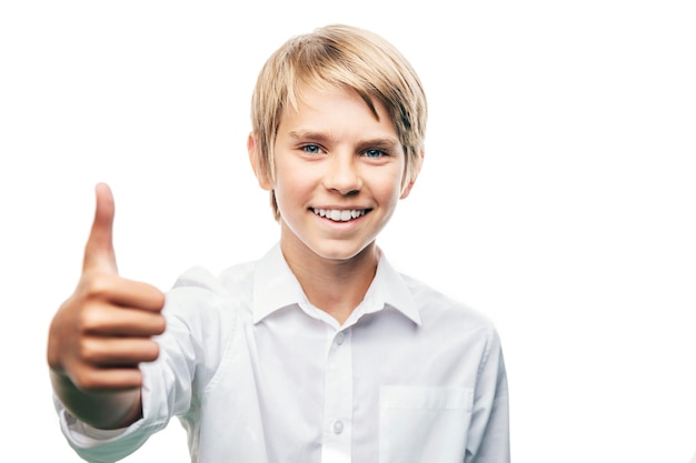 Contented boy in white showing blurred thumb up