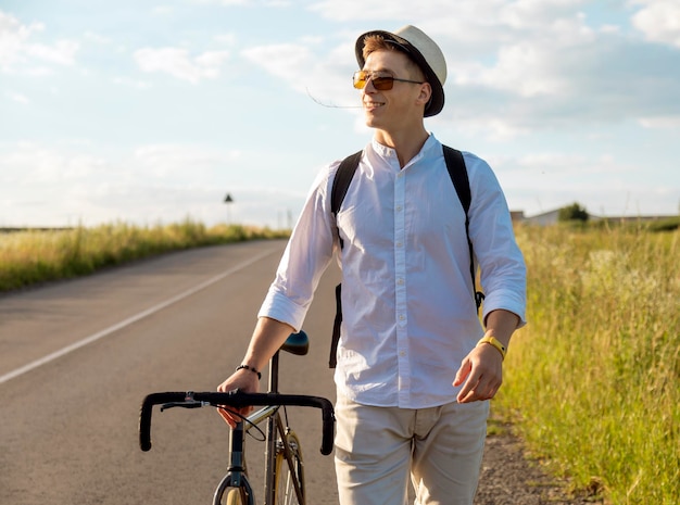 Contented cyclist guy walking by feet